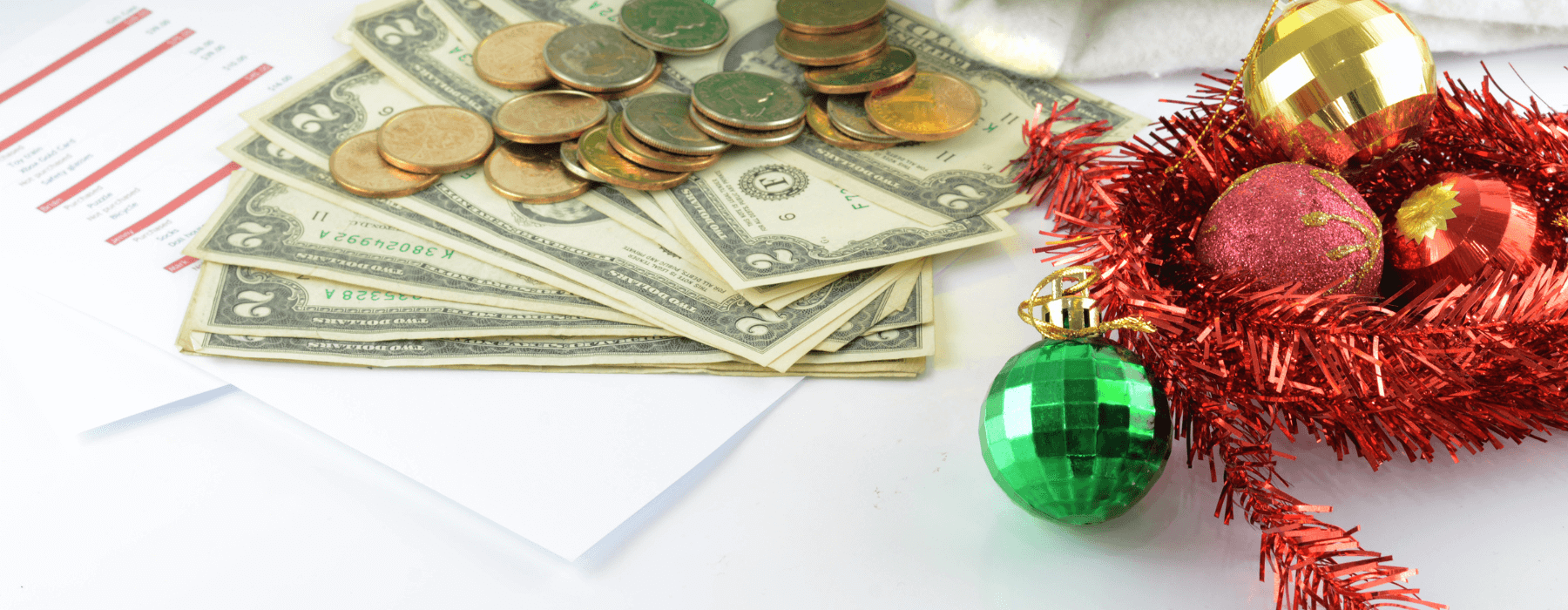 A festive scene with holiday decorations and stacks of cash and coins.