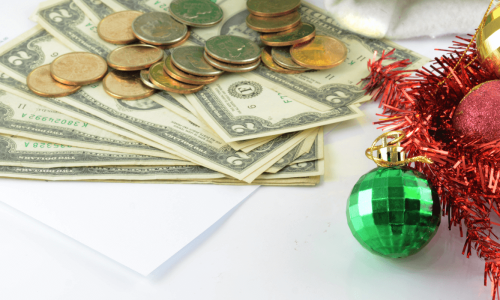 A festive scene with holiday decorations and stacks of cash and coins.