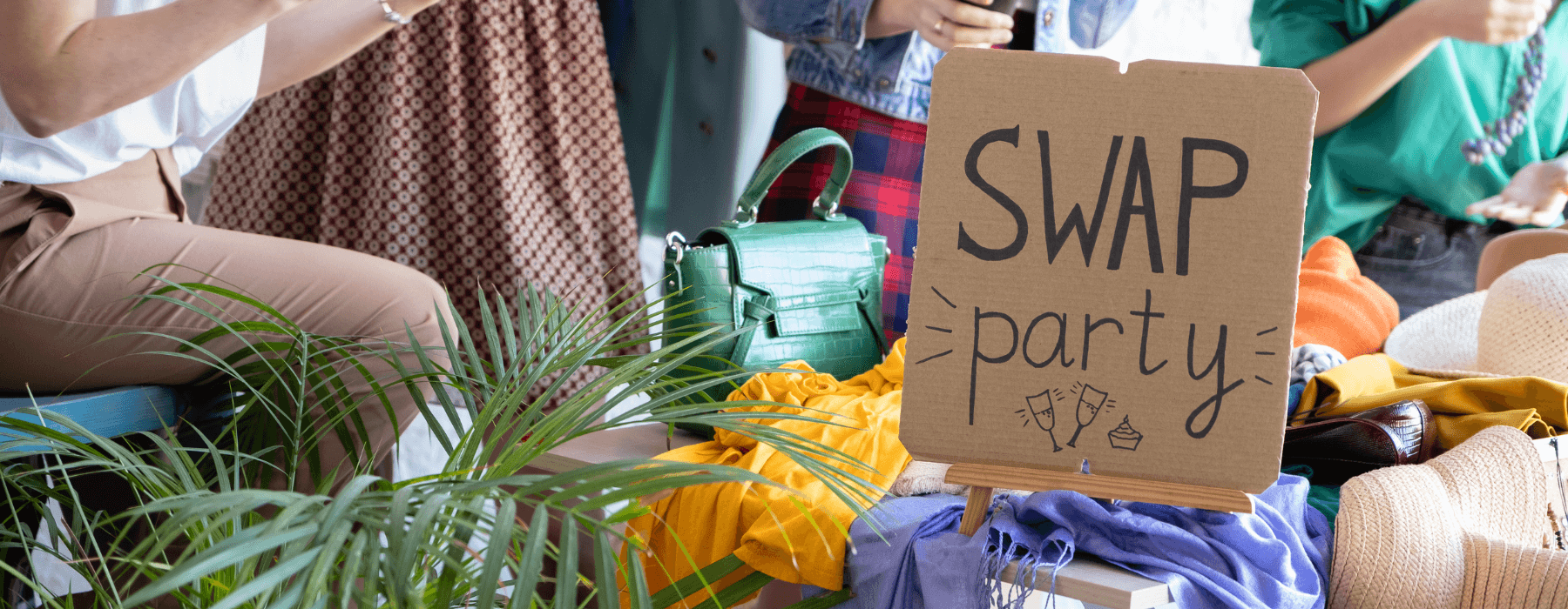 A clothing and accessory swap party setup with a sign reading 